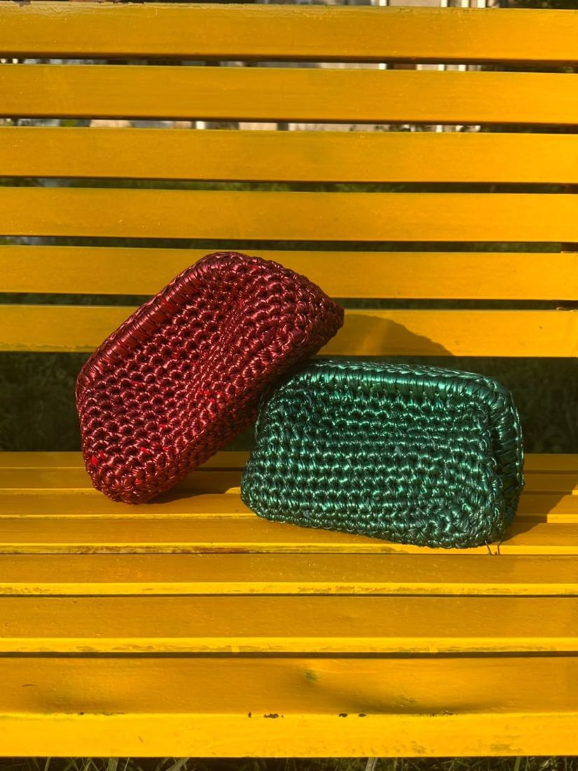 Rouge and Emerald Dome Clutches on a yellow park bench